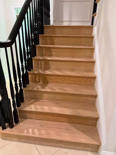 Natural oak stair treads with black balusters