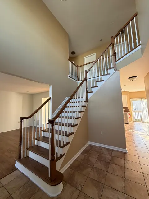 Curved staircase with refinished oak treads and white balusters