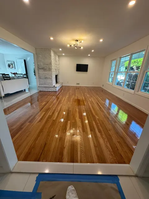 Large open living room with newly refinished oak floor