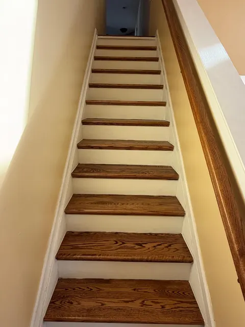 Straight staircase with refinished treads and white risers